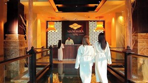 A lobby with a reception desk, a sign reading "MANDARA SPA", and a glass elevator. - Harborside Resort - Two Bedroom Small - Full Resort Access (Paradise Island)