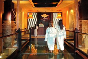 A lobby with a reception desk, a sign reading "MANDARA SPA", and a glass elevator. - Harborside Resort - 3 Bedroom - Full Resort Access (Paradise Island)