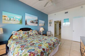 A bedroom with a bed, nightstands, a chair, and artwork on the walls. - 2BR Penthouse Paradise: Suntide III - Unit 1202 (South Padre Island)