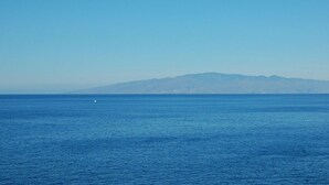 A clear view of a calm sea with a distant mountain range under a clear sky. - El Mango House with private pool (Candelaria)