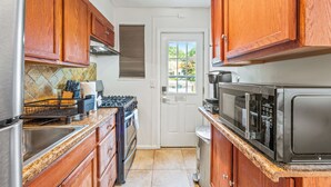 A kitchen with wooden cabinets, a stainless steel refrigerator, a gas stove, a microwave, and a dishwasher. - ❃Free Parking ❃ 2 King Beds ❃ Fenced Yard❃ ~ Floyd's Freedom ~ (Alexandria)