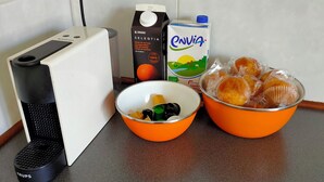 A kitchen counter with a coffee maker, a bowl of fruit, a carton of milk, and a basket of muffins. - Relax, silence and sun in the Basque Country (Hendaya)