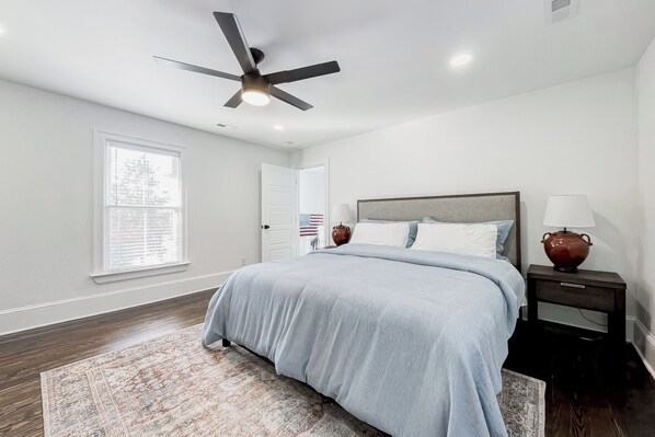 A bedroom with a bed, a ceiling fan, a nightstand, and a window. - Pets Welcome! Family-Friendly Retreat in Culpeper (Culpeper)