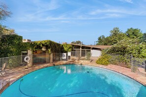 A clear blue swimming pool surrounded by a wooden deck and a metal fence. - Poolside Oasis! Phoenix Group Sanctuary w/ Patio (Phoenix)