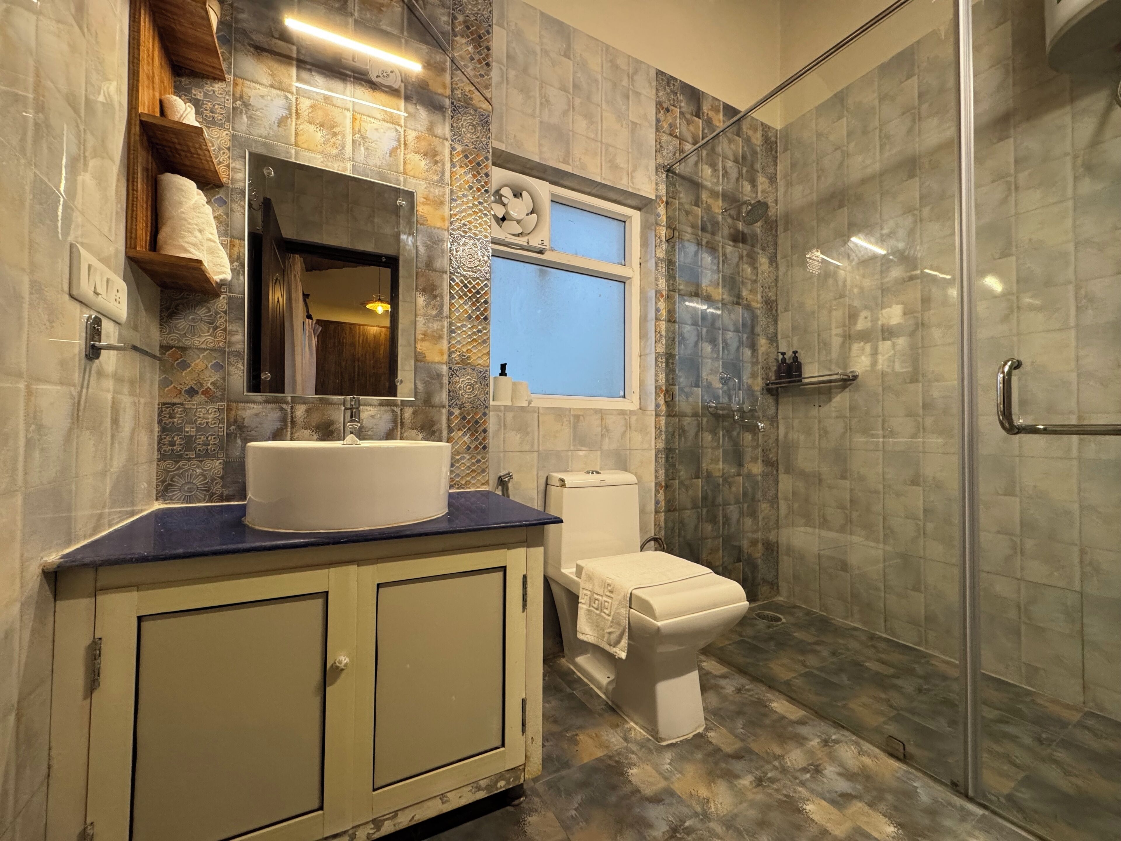 A bathroom with a sink, toilet, and shower.