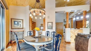 A dining area with a round table, chairs, and a chandelier. There are wooden floors and a wooden ceiling. - Golf, Trails & Lakes! Show Low Home w/ Bonus Suite (Show Low)