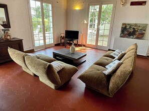 A living room with two sofas, a coffee table, a television, and a painting on the wall. - Spanish country house with bay views A0386 (Lège-Cap-Ferret)