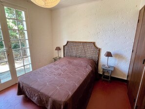 A bedroom with a bed, two bedside tables, a window, and a door. - Vacation home with wonderful terrace and far-reaching views to the bay (Lège-Cap-Ferret)