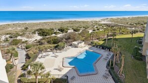 A resort with a large pool, beach view, and landscaped garden. - Surf & Racquet B170 - Hosted by Moore AI Rentals (Fernandina Beach)