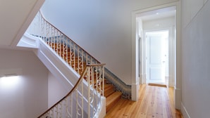 A staircase with ornate white railings and a wooden finish, leading to a door marked with the number 20. - The Restauradores Collection - Majestic (Lisboa)