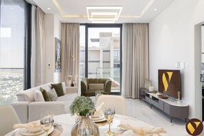 Luxury Apartment, Balcony, City View | Living area | 65-inch Smart TV with cable channels - Vogue | The Pinnacle near Dubai Hills Mall (Dubai)