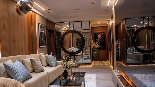 A modern living room with a sofa, coffee table, and decorative mirrors. - One Bedroom Luxury apartment in Maitama, Abuja (Abuja)