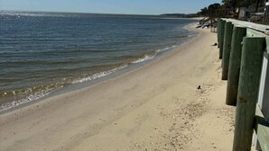 A beach with a wooden walkway and a clear view of the ocean. - 4-bedroom Luxury Private Beach Getaway (Scotland)