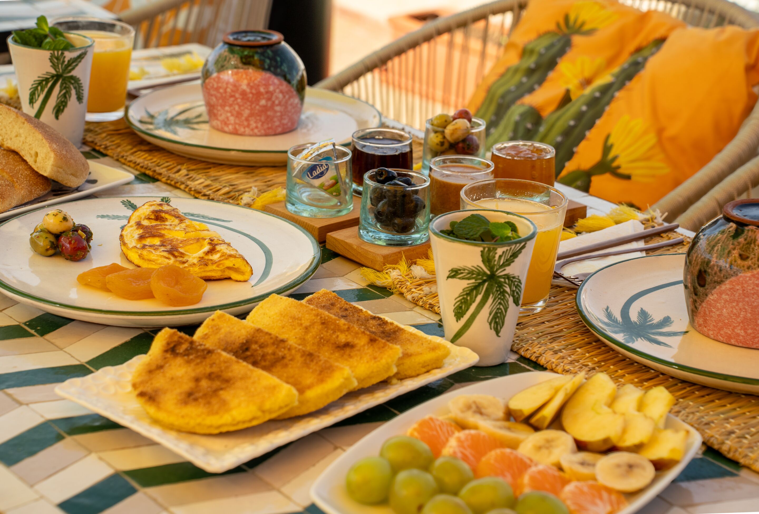 A breakfast table with plates of toast, fruit, and beverages.