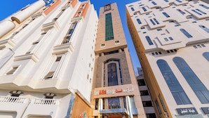 A hotel with a modern facade, multiple balconies, and a prominent entrance with signage. - Sama Almisk Hotel (Makkah)
