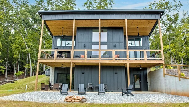 A two-story cabin with a balcony, outdoor seating, and a fire pit. - NEW - Luxury Mountain Retreat - Walk to Redtail Vineyard (Blairsville)