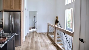 A kitchen with wooden cabinets and a stainless steel refrigerator. - NEW - Luxury Mountain Retreat - Walk to Redtail Vineyard (Blairsville)
