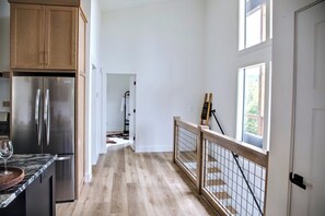 A kitchen with wooden cabinets and a stainless steel refrigerator. - NEW - Luxury Mountain Retreat - Walk to Redtail Vineyard (Blairsville)