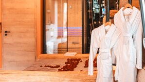 A hotel room with wooden flooring, a wooden door, and a glass shower area. - Chalet Angora - Nature Suite & Spa in Fustes (Carspach)