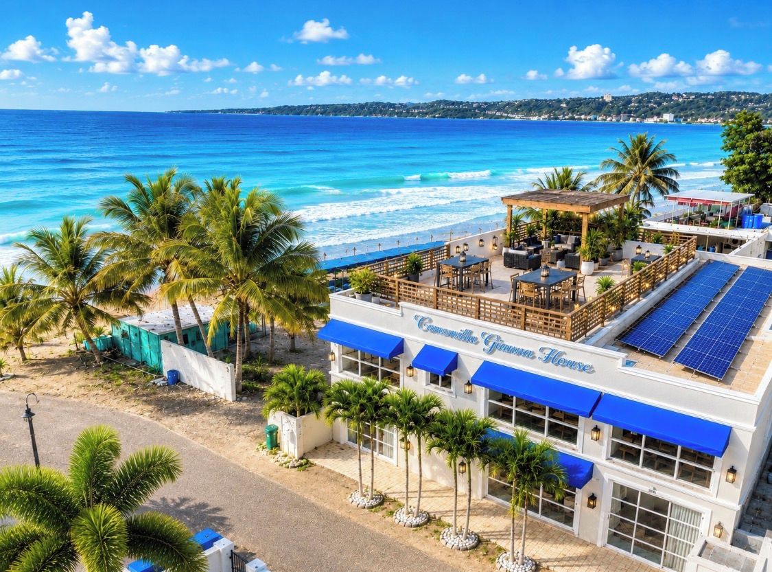 A beachfront hotel with a pool area, outdoor seating, and solar panels.