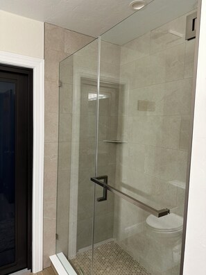 A glass-enclosed shower stall with a glass door, a metal handrail, and a tiled floor. - 3 bed/2 bath pool home & hot tub in Naples. Great neighborhood. 3 miles to beach (Naples)