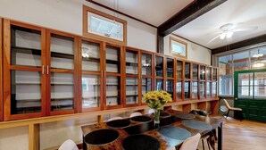A dining area with a wooden table, chairs, and a vase of flowers. - Deck, Views, Games: 10BR Home in Shenandoah Valley (McDowell)