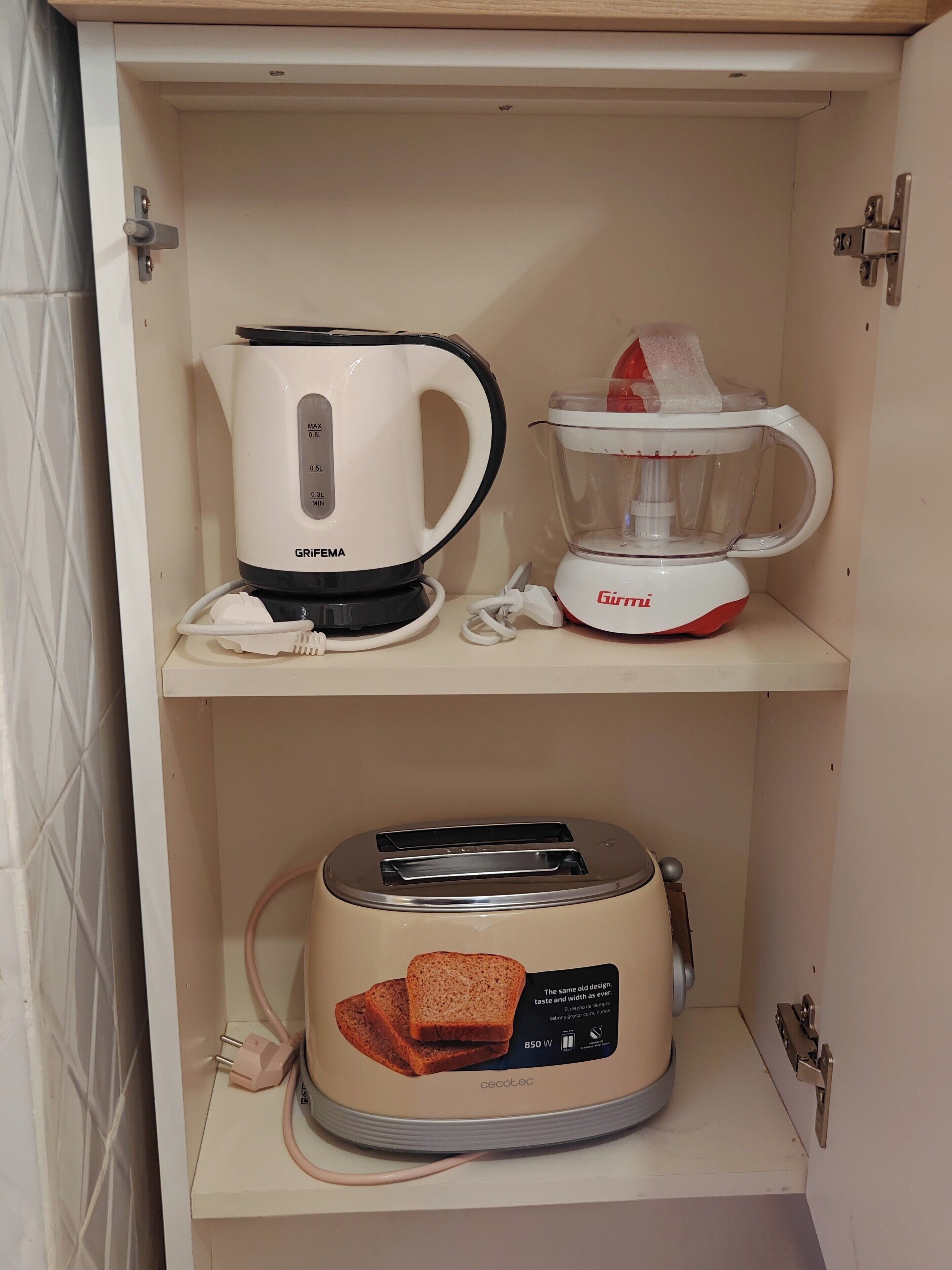A kitchen with a coffee maker, blender, and toaster on open shelves.