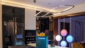 A modern kitchen with a central island, built-in appliances, and a unique lighting fixture. - Two Bedroom Luxury Apartment in Maitama, Abuja (Abuja)