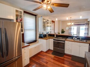 A modern kitchen with a stainless steel refrigerator, built-in microwave, and gas stove. - The Bonney Grey Guesthouse in Grafton – Sleeps 12 (Grafton)