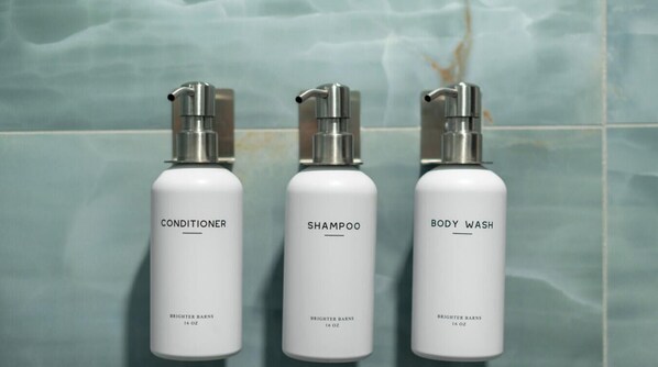 Three bottles of Brightner Barns products: conditioner, shampoo, and body wash, each labeled with 16 oz. - The Mystic River Inn (Groton)