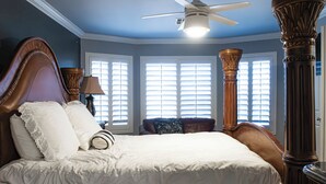 A bedroom with a large bed, a ceiling fan, and a window with blinds. - Group-Ready Glendale Oasis w/ Pool Grotto + Slide (Glendale)