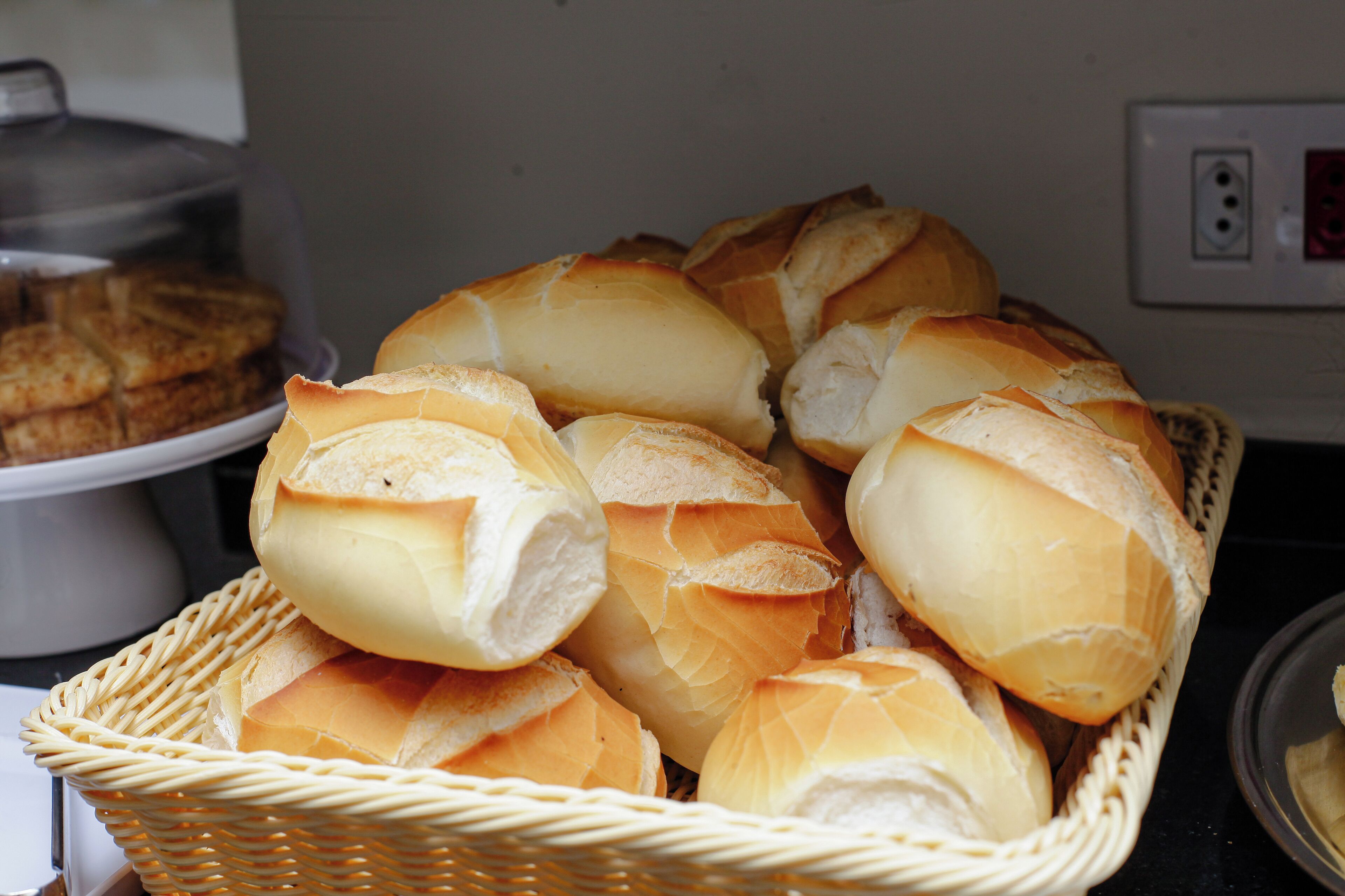 A basket of baguettes on a table.
