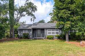 A single-story house with a front porch, a garage, and a well-maintained lawn.