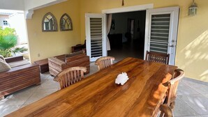 A spacious dining area with a large wooden table and several wooden chairs. - ~Nos Yemaya~ 2BR+Pool ~ Walking distance to playa Lagun! (Lagun)