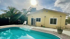A swimming pool with a house in the background. - ~Nos Yemaya~ 2BR+Pool ~ Walking distance to playa Lagun! (Lagun)