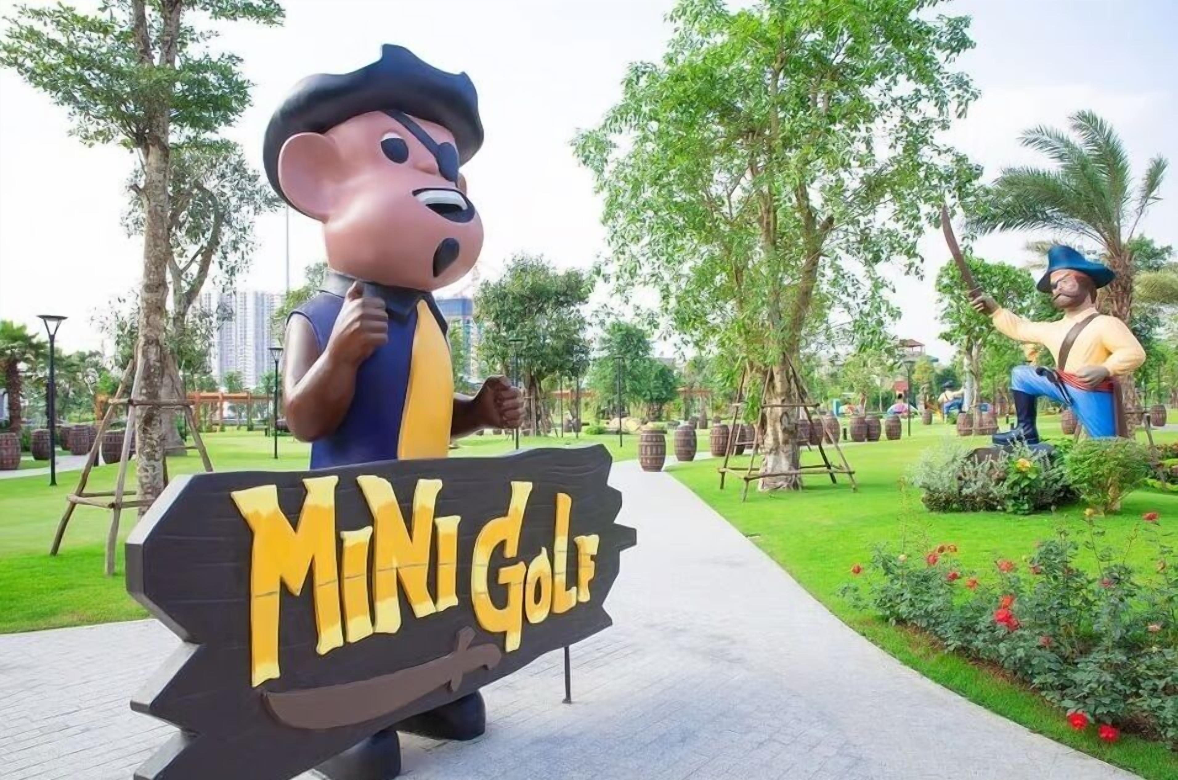 A sign for 'Mini Golf' with a cartoon character and a person in a costume.