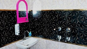 A bathroom with a sink, mirror, and shower. - The Ayodhya Ji palace (Ayodhya)