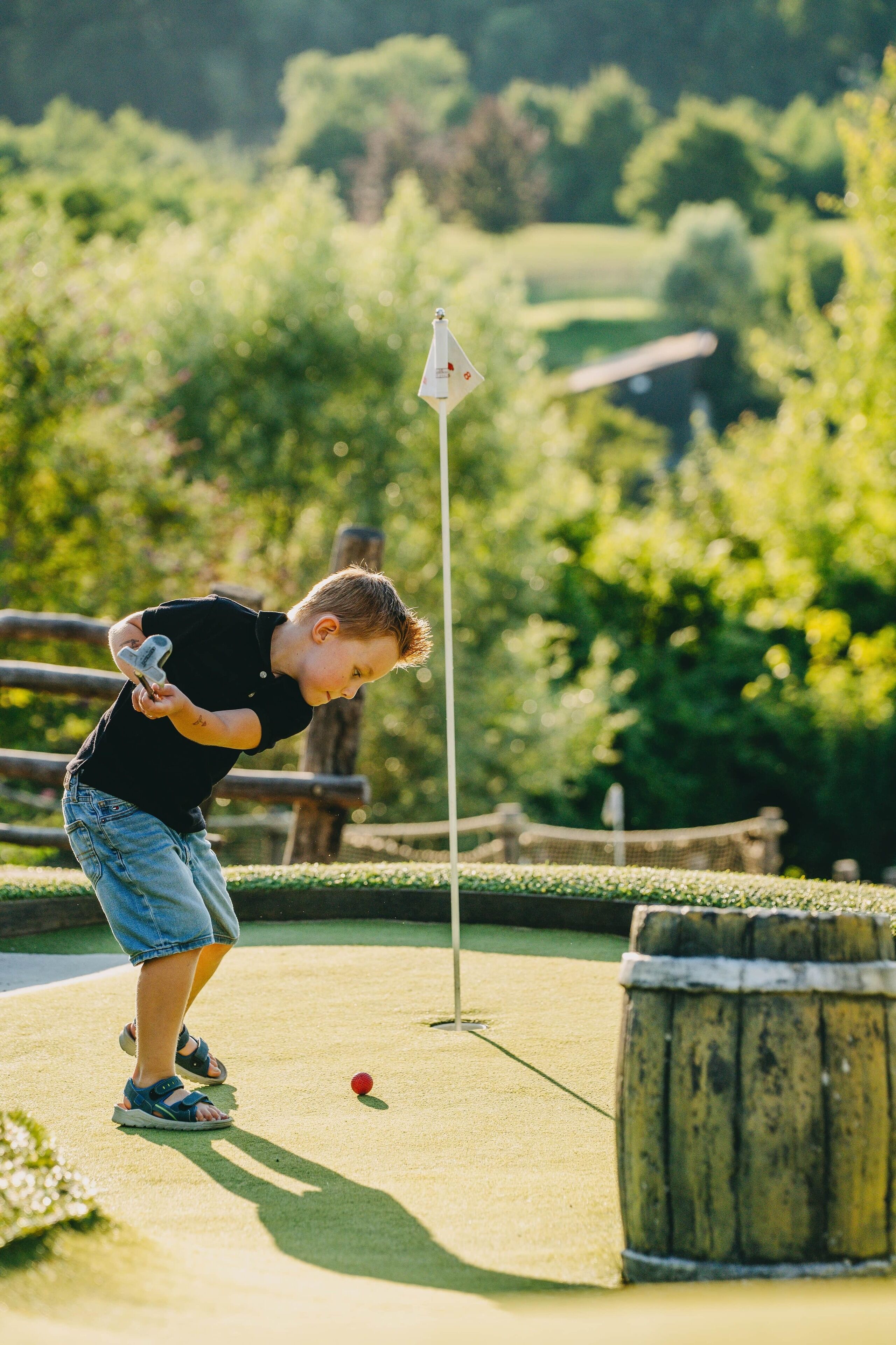 A person playing golf on a sunny day.
