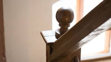 A wooden staircase with a rounded baluster.