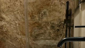 A white vessel sink with a single faucet in a bathroom with marble walls. - Gregory Lem collection (Rome)