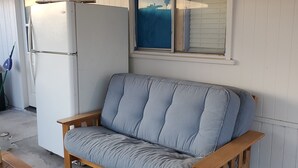 A wooden bench with a cushion, a white refrigerator, and a window with blinds. - Compact Studio Lovely, Privacy Affordable safe And Quite #3 (Phoenix)
