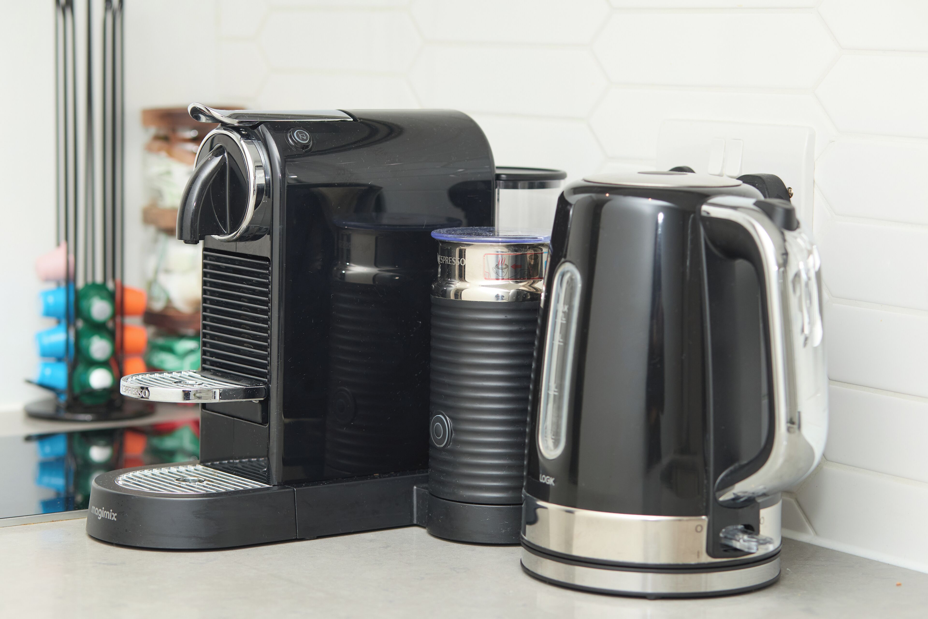 A coffee maker and a kettle on a countertop.