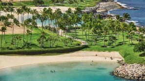 A coastal resort with palm trees, a beach, and a golf course. - Luxury Oasis Resort Villa (Kapolei)