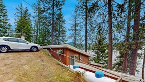 A cabin with a wooden exterior, a small porch, and a white water tank. - Dock, Deer Lake Access! Fishermen's Paradise (Loon Lake)