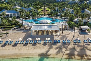 A resort with multiple swimming pools, a beach area with sun loungers, and a covered dining area. - Relax, Rejuvenate, Explore at Westin St. John Resort - 2 bedroom/3 bathroom unit (Cruz Bay)
