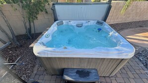 A hot tub with a control panel, two step stools, and a pool brush. - Stylish Tucson Getaway • Pool • Hot Tub • Game Zone - Sleeps 7 (Oro Valley)