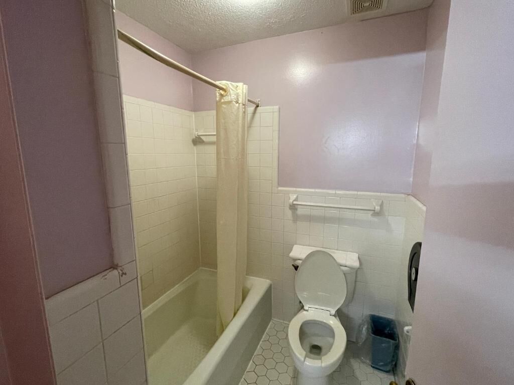 Bathtub, towels, soap, toilet paper
