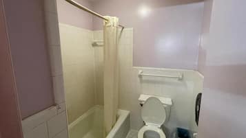 Bathtub, towels, soap, toilet paper