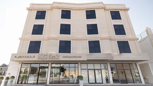 A multi-story hotel with a modern facade, large windows, and a sign indicating it is the Royal Edition Hotel. - Royal Edition Hotel Apartments (Buraydah)