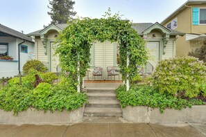 A house with a green door, a porch, and a staircase leading to the front door. - Steps to Sand: 'Beach Hill Bungalow' w/ Patio (Santa Cruz)